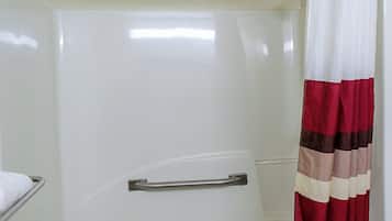 A bathroom with a white shower enclosure, a towel rack, and a striped shower curtain.