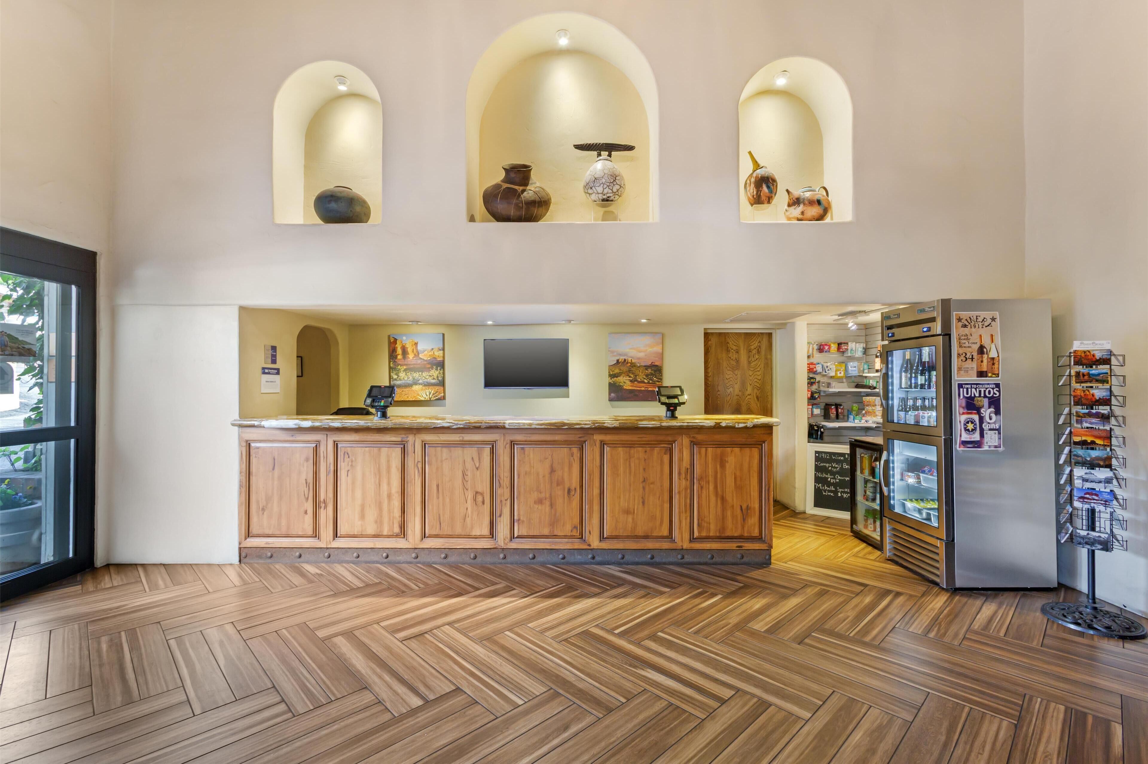 A spacious kitchen with wooden cabinets, a central island, and a refrigerator with a drink dispenser.