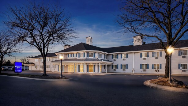 A large, two-story hotel with a symmetrical facade, multiple windows, and a central entrance.