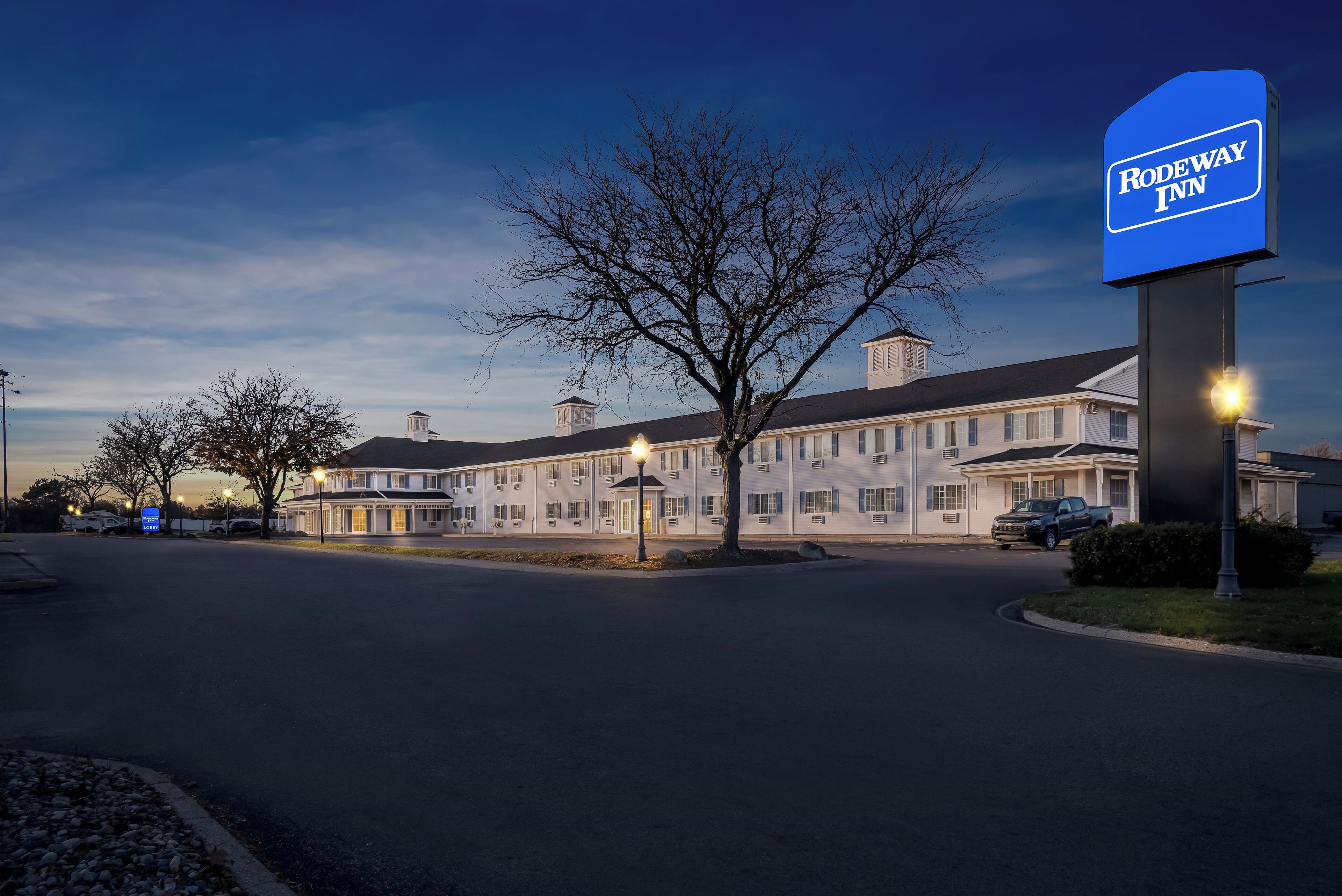 A large, two-story hotel with a prominent sign for the Rodeway Inn.