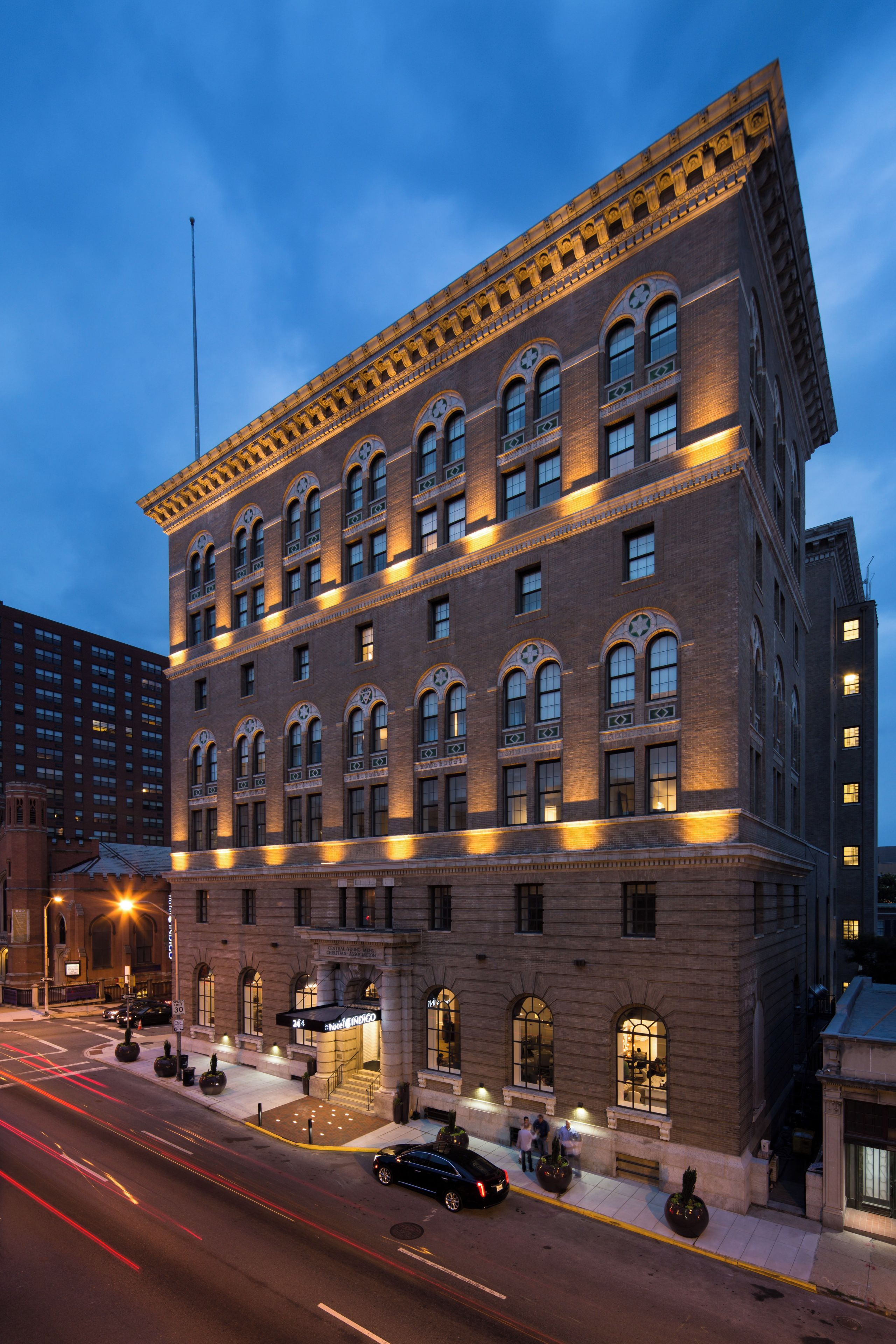 A multi-story hotel with a classic architectural style, featuring arched windows and decorative trim.