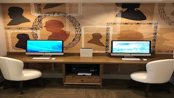 A workspace with two monitors, a keyboard, a mouse, and two chairs.