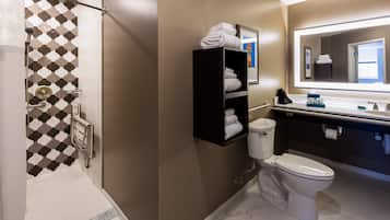 A modern bathroom with a shower, toilet, and a towel rack.