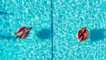 Guests can enjoy a refreshing swim in the pool, surrounded by a unique tile pattern.