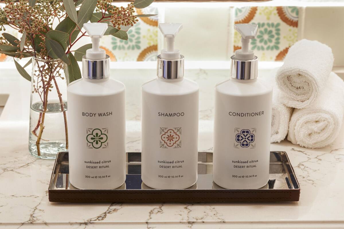 Three bottles of skincare products on a tray.