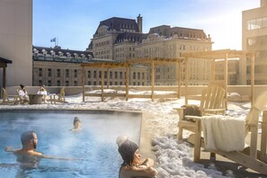 Outdoor pool, a heated pool, pool loungers, lifeguards on site