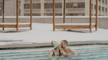 Outdoor pool, a heated pool, pool loungers, lifeguards on site