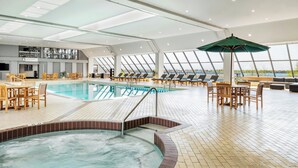 A spacious indoor swimming pool area with a hot tub, sun loungers, and a dining area. - The Westin Harbour Castle, Toronto (Toronto)