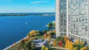 A high-rise hotel with a parking lot and autumn foliage. - The Westin Harbour Castle, Toronto (Toronto)