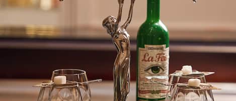 A bar setting with a decorative ice lamp, a bottle of La Fèvre, and two glasses with candles.
