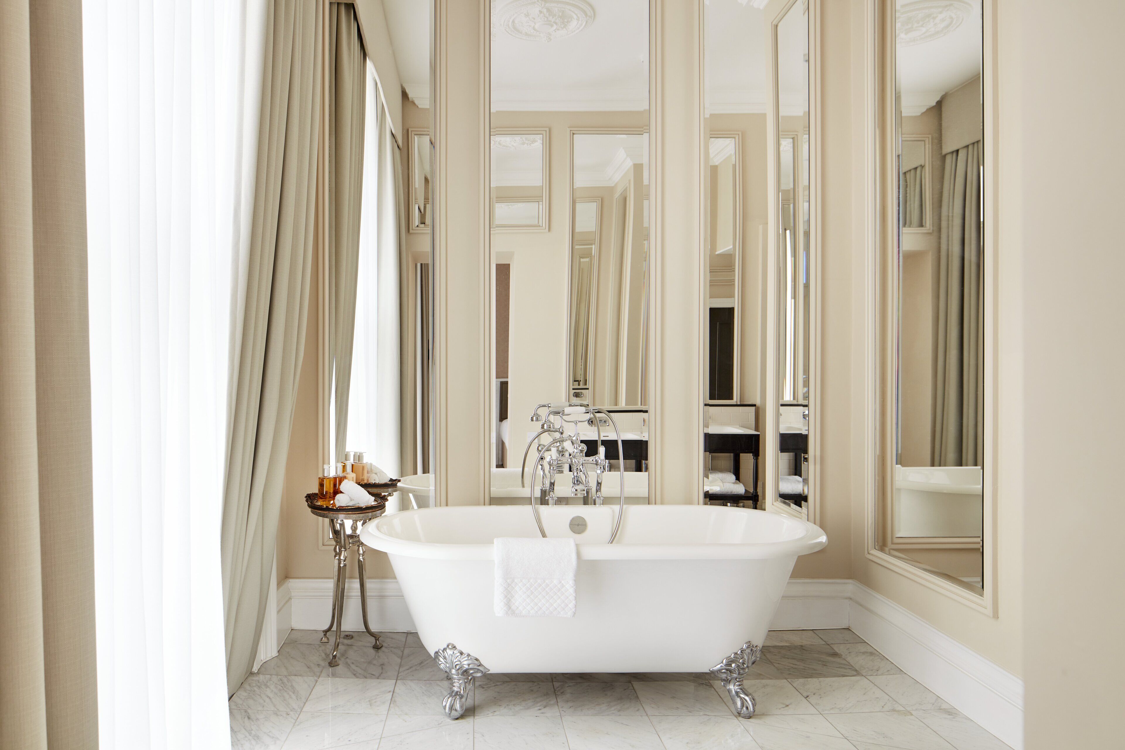signature suite | bathroom | rainfall showerhead, designer toiletries, hair dryer, towels