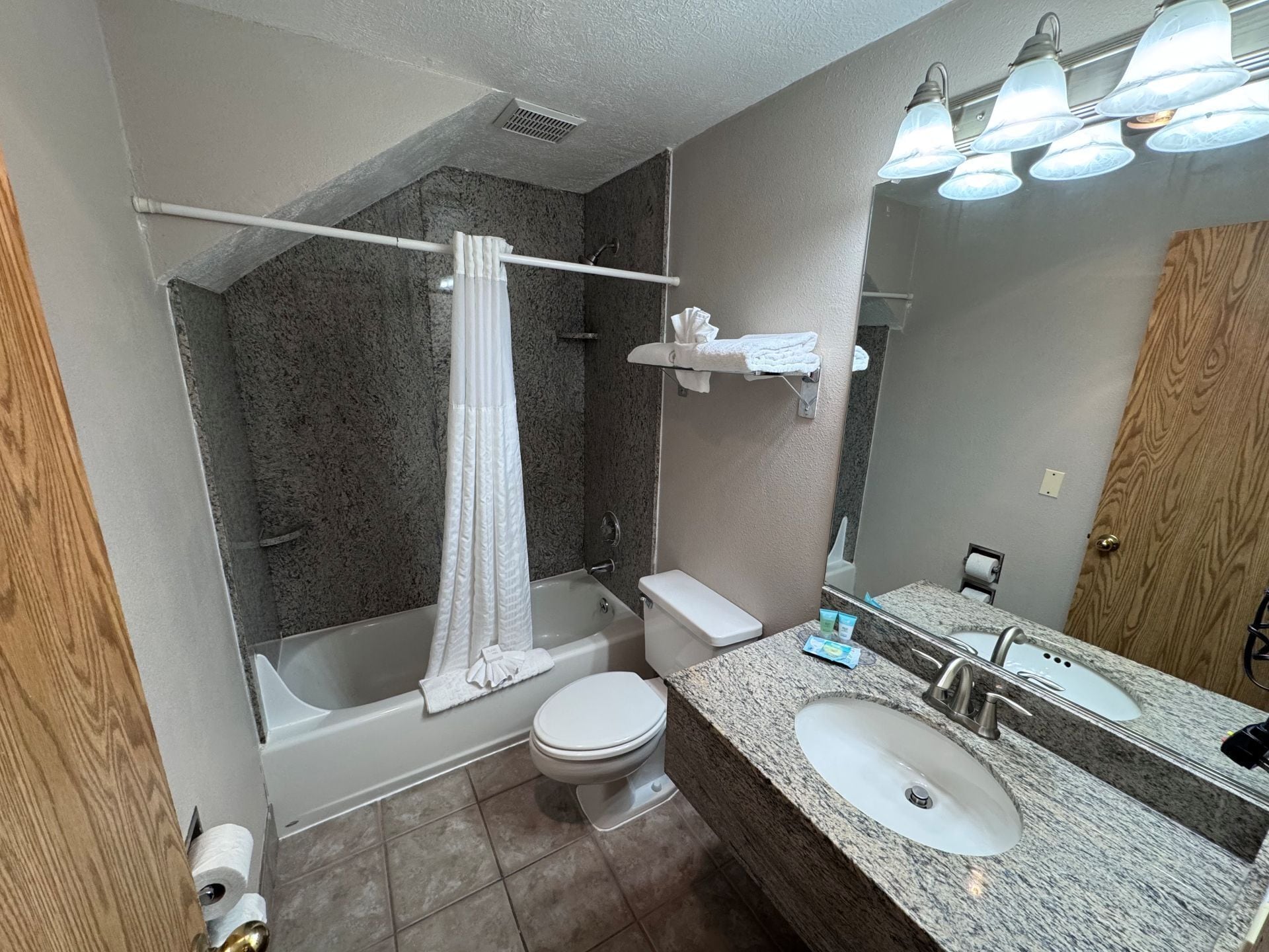 A bathroom with a bathtub, toilet, and sink.