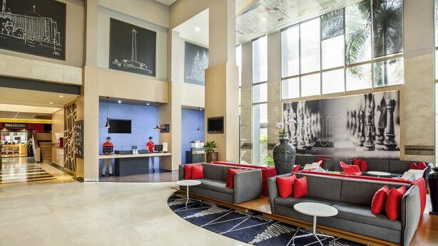 A spacious lobby with a reception desk, seating area, and large windows. - Asyana Kemayoran Jakarta (Jakarta)