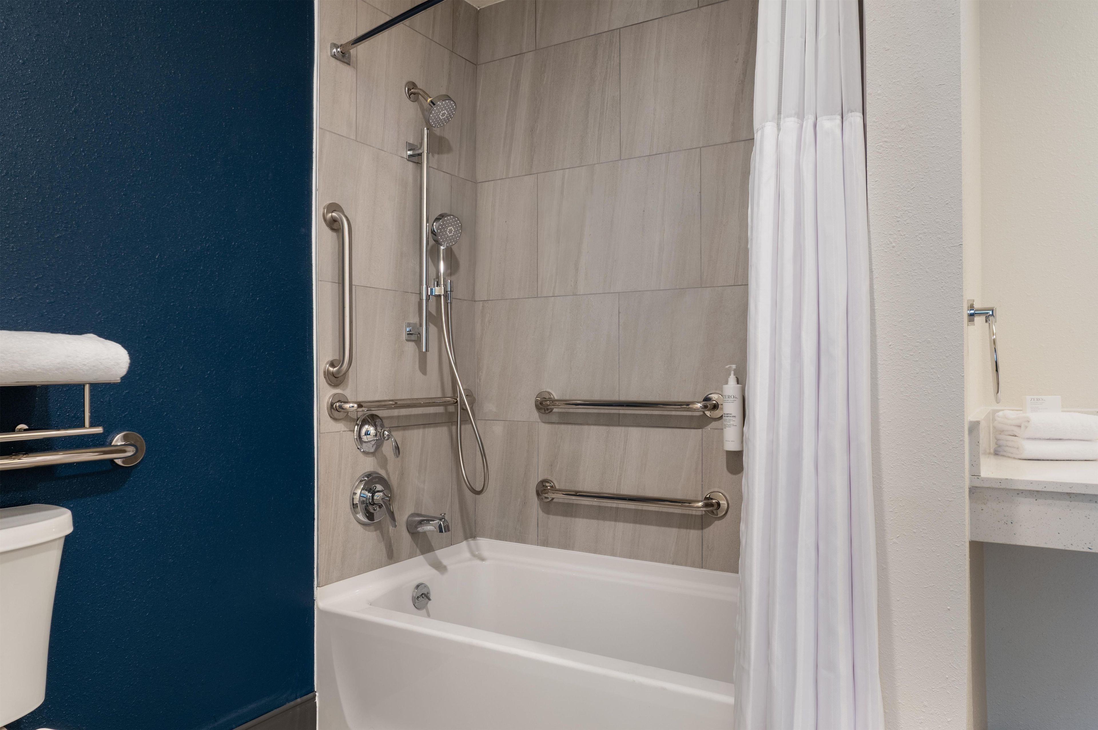 A bathroom with a bathtub, a shower, and a toilet.