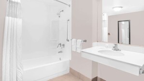 A bathroom with a bathtub, shower, and sink. - Super 8 by Wyndham Austell/Six Flags (Austell)
