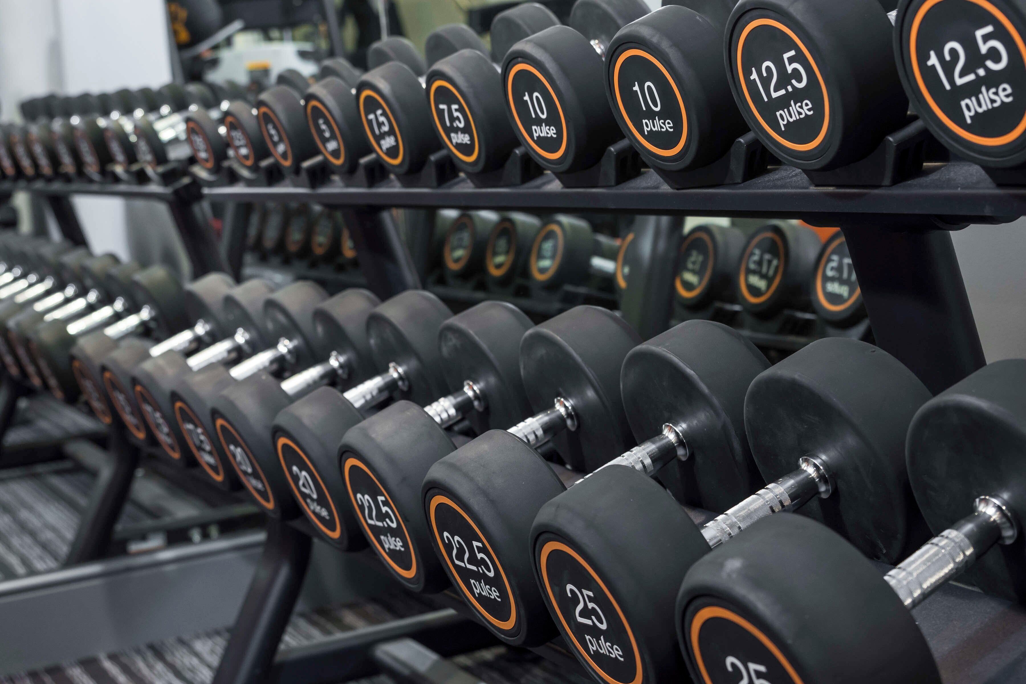 A rack of dumbbells with weight markings.