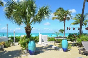 On the beach, white sand, sun loungers, beach umbrellas