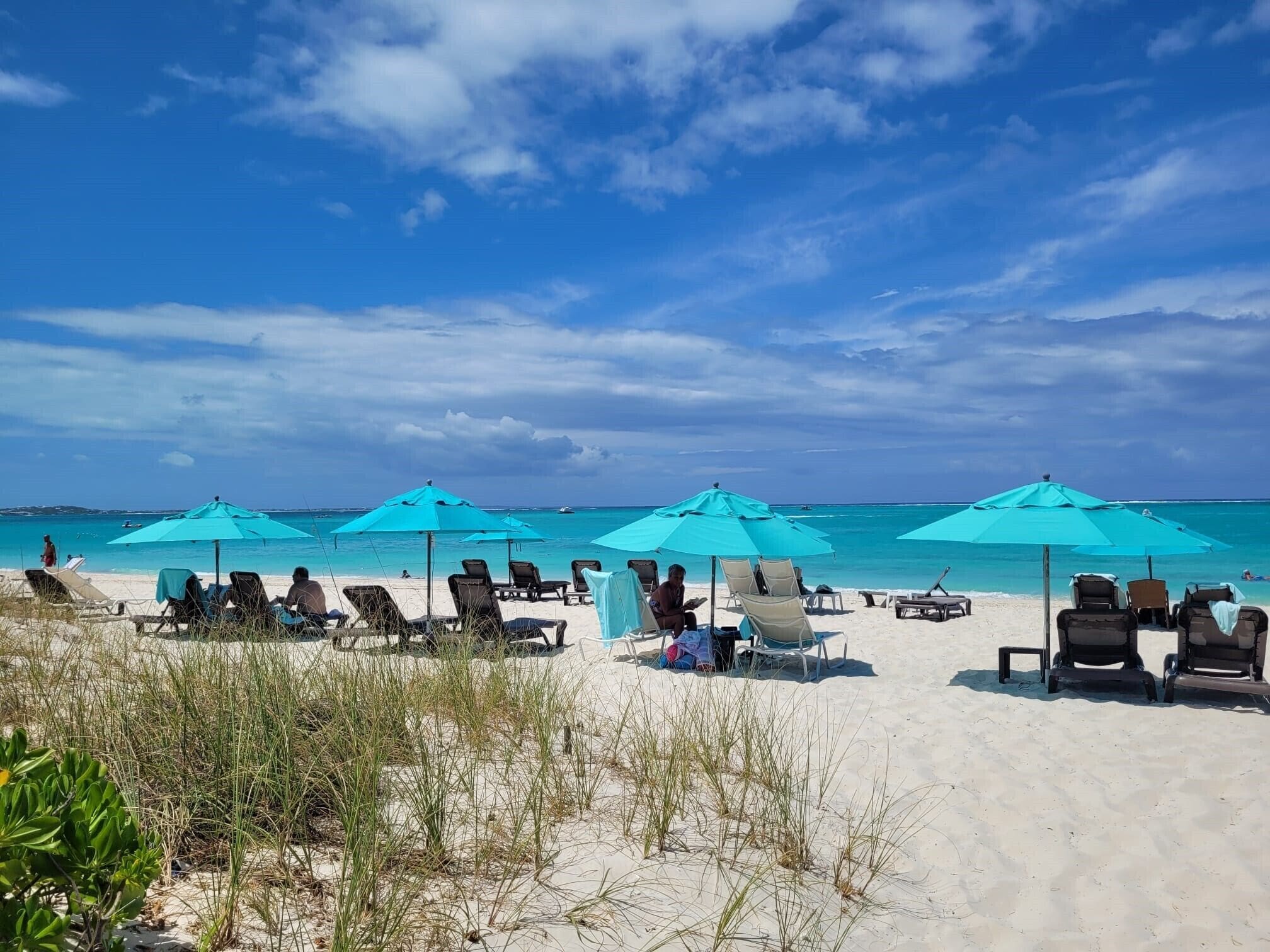 on the beach, white sand, sun-loungers, beach umbrellas
