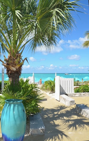 On the beach, white sand, sun loungers, beach umbrellas