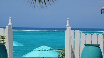 On the beach, white sand, sun loungers, beach umbrellas