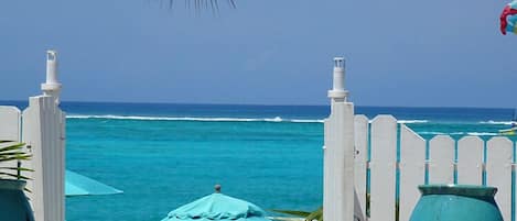 On the beach, white sand, sun loungers, beach umbrellas