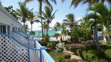 Un resort con piscina, palmeras y vista al océano.