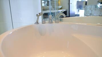 A bathroom sink with two faucets and a mirror above it.