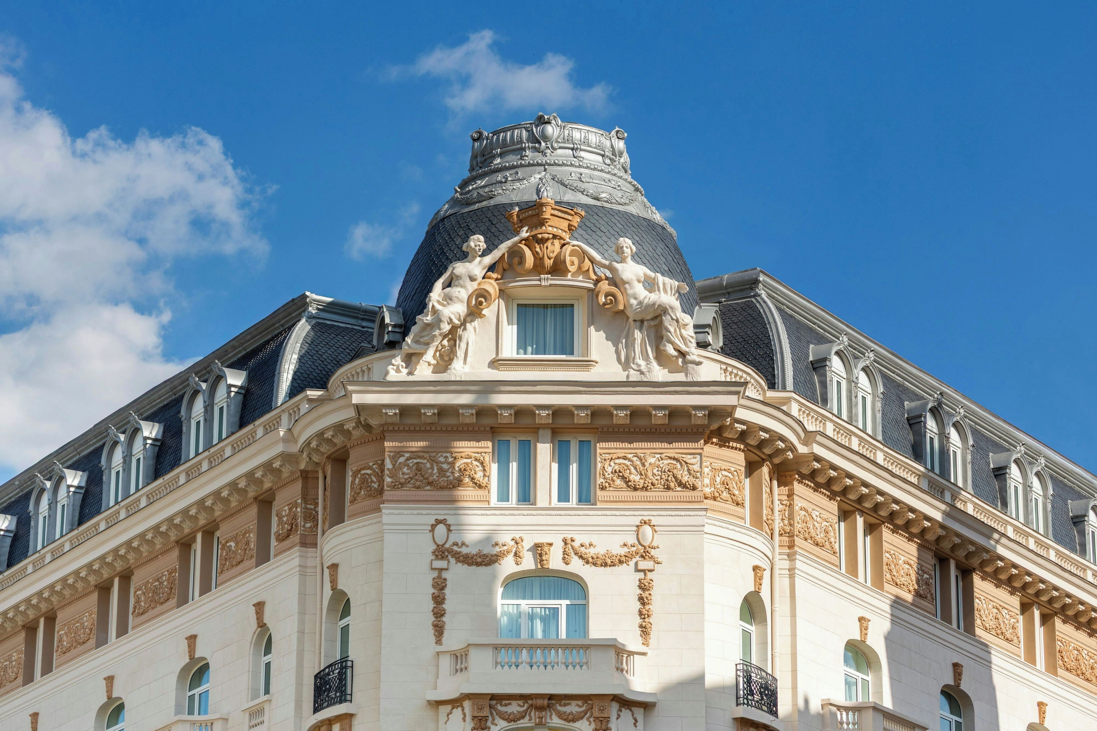 A building with ornate architectural details, including sculptures and decorative moldings.