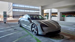 A modern building with large windows and a parking area with a charging station. - The Westin Southfield Detroit (Southfield)