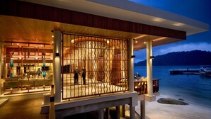 A modern waterfront hotel with a covered outdoor area, a pool, and a view of the water. - Pangkor Laut Resort  (Pangkor Laut)