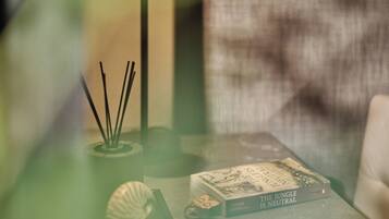 A table with a book titled 'The Jungle is Neutral' and a lamp with a green shade.