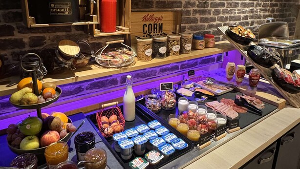 A breakfast buffet with various food items and condiments. - Kyriad Lisieux (Lisieux)