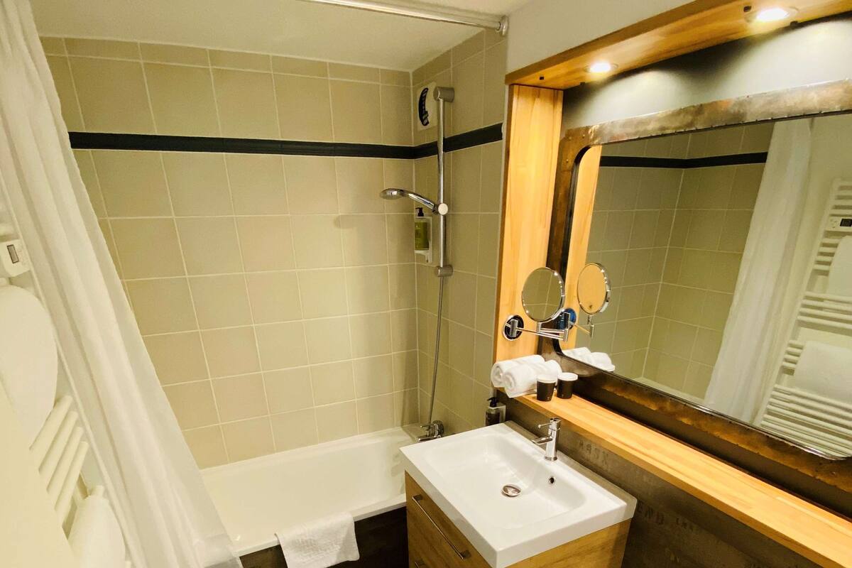 A bathroom with a bathtub, a sink, a toilet, and a shower.
