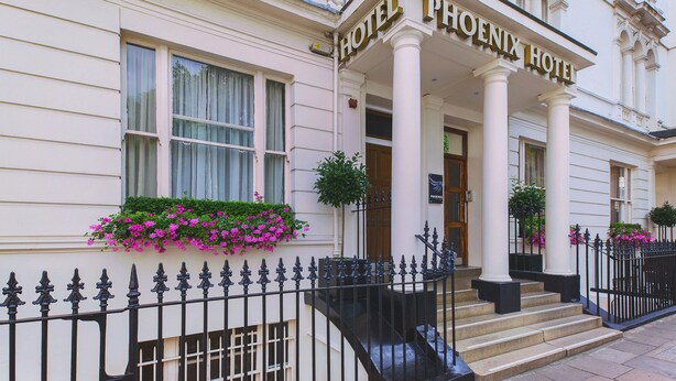 The exterior of the Phoenix Hotel with a classic facade, large columns, and a welcoming entrance. - Phoenix Hotel (London)