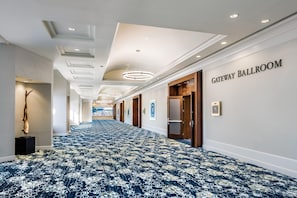 A hotel corridor with a patterned carpet, a wall sign reading 'GATEWAY BALLROOM', and a sculpture on the left. - DoubleTree by Hilton San Jose (San Jose)