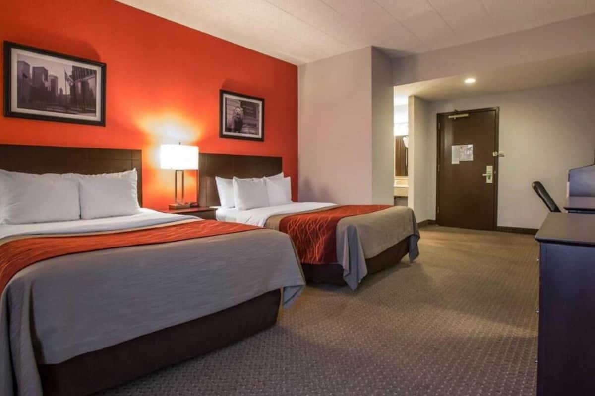 Premium bedding, desk, laptop workspace, blackout drapes