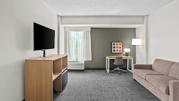 Premium bedding, desk, laptop workspace, blackout drapes