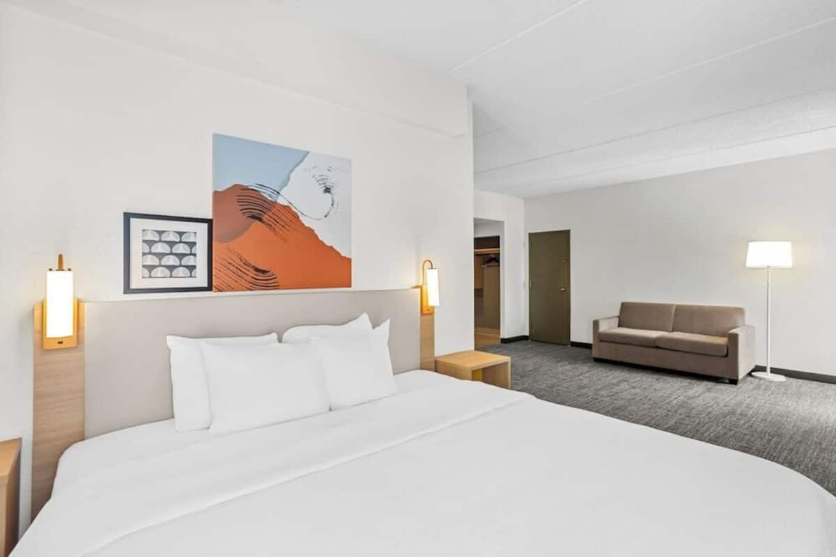 Premium bedding, desk, laptop workspace, blackout drapes
