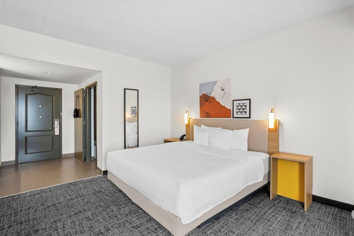 Premium bedding, desk, laptop workspace, blackout drapes