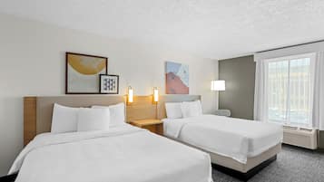 Premium bedding, desk, laptop workspace, blackout drapes