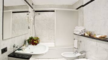 A modern bathroom with a shower, bidet, toilet, and sink.