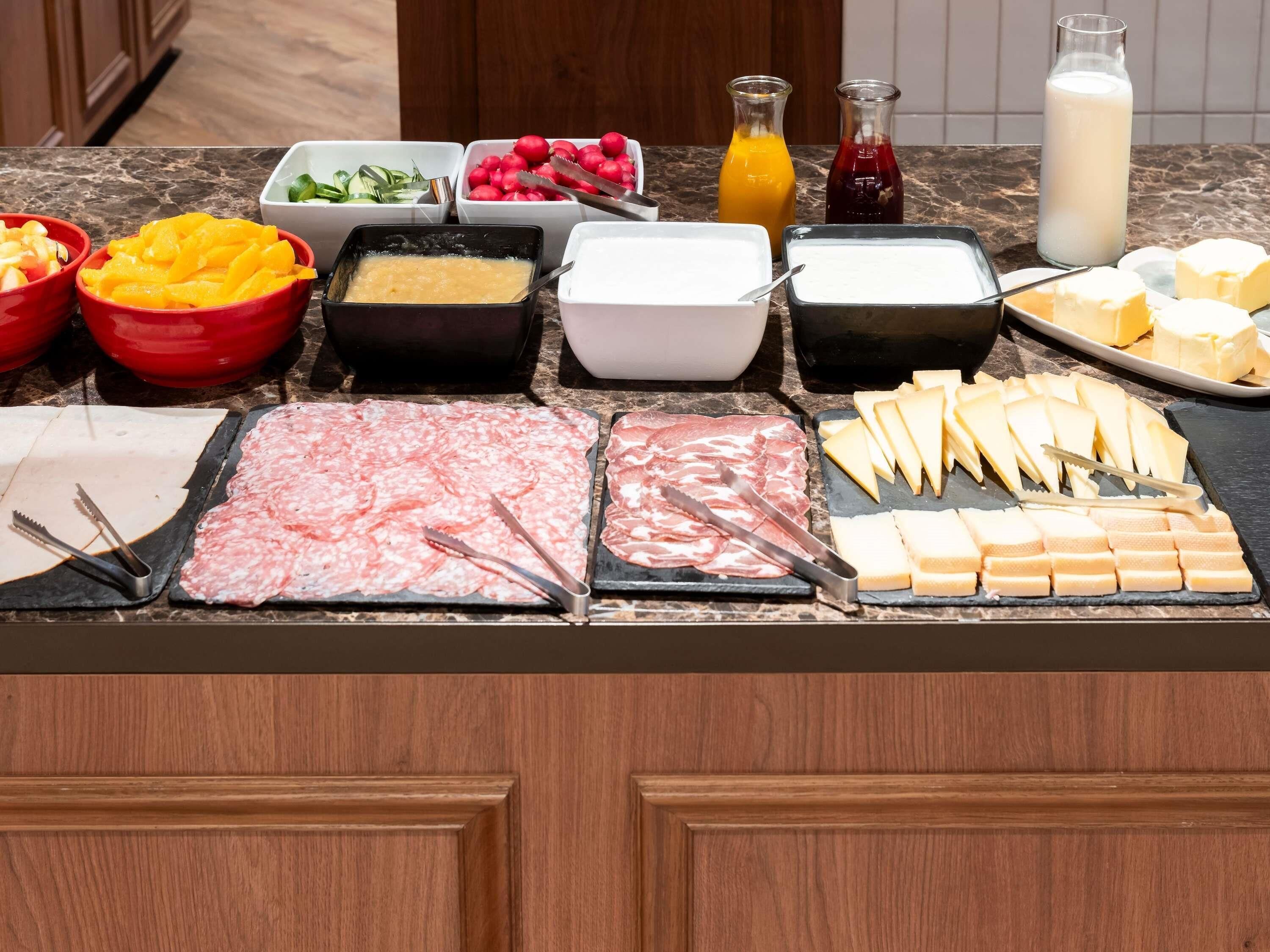 A buffet with various food items and condiments.