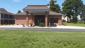 A two-story building with a brick facade, a flat roof, and a covered entrance area. - Howard Johnson by Wyndham Florence (Florence)