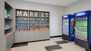 A vending area with snack and drink options, including Pepsi refrigerators and a 'MARKET' display with various products. - Howard Johnson by Wyndham Florence (Florence)