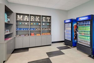 A vending area with snack and drink options, including Pepsi refrigerators and a 'MARKET' display with various products.