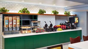 A breakfast bar with various food items and a waffle maker. - Best Western Plus Meridian Inn & Suites, Anaheim-Orange (Orange)
