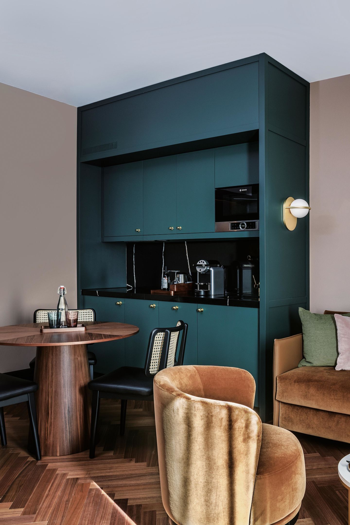 A compact living space with a dining area, a kitchenette, and a seating area.