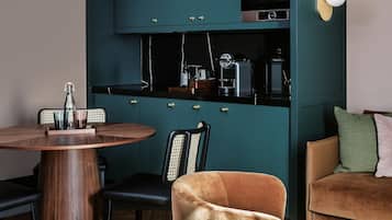 A compact living space with a dining area, a kitchenette, and a seating area.