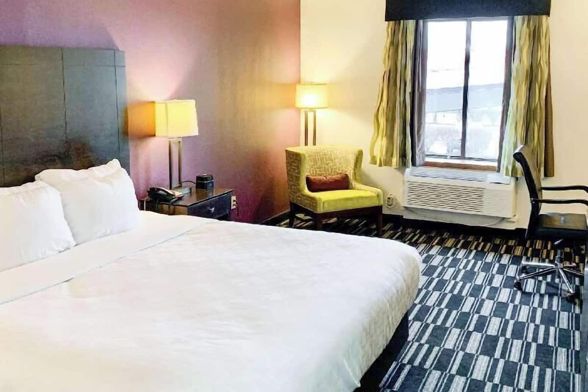 Premium bedding, desk, laptop workspace, iron/ironing board