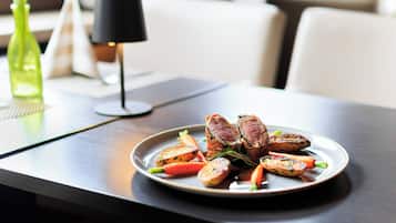 A plate of food on a table with a lamp in the background.